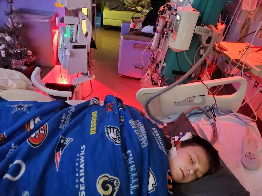 Kid Captain Cooper Estenson sleeping in hospital bed
