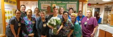 Group photo of Claudia Bedell, BSN, RN and the Mother-Care Baby Unit (MBCU)