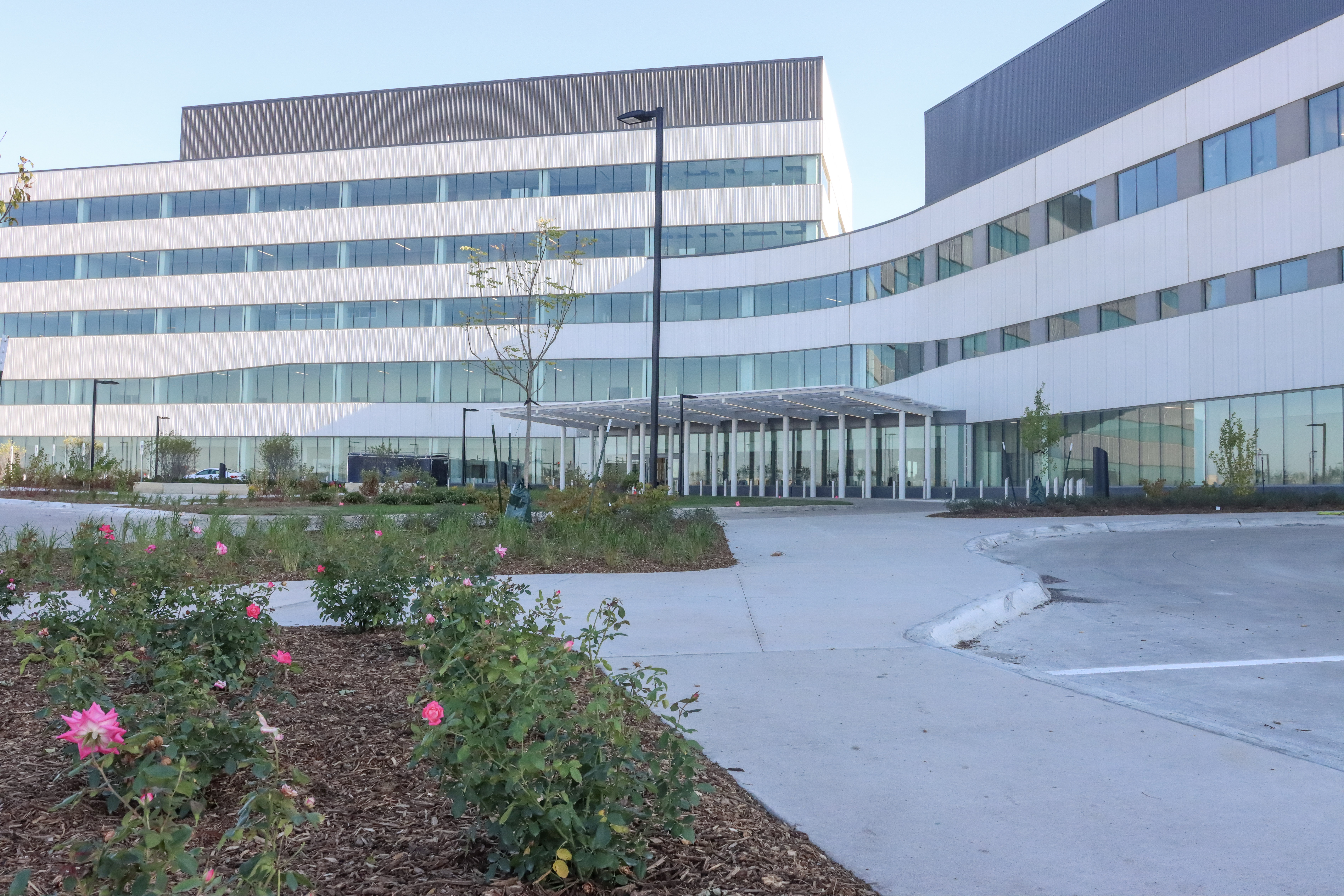 The exterior of the UIHC building, showcasing its modern architecture and beautiful landscaping