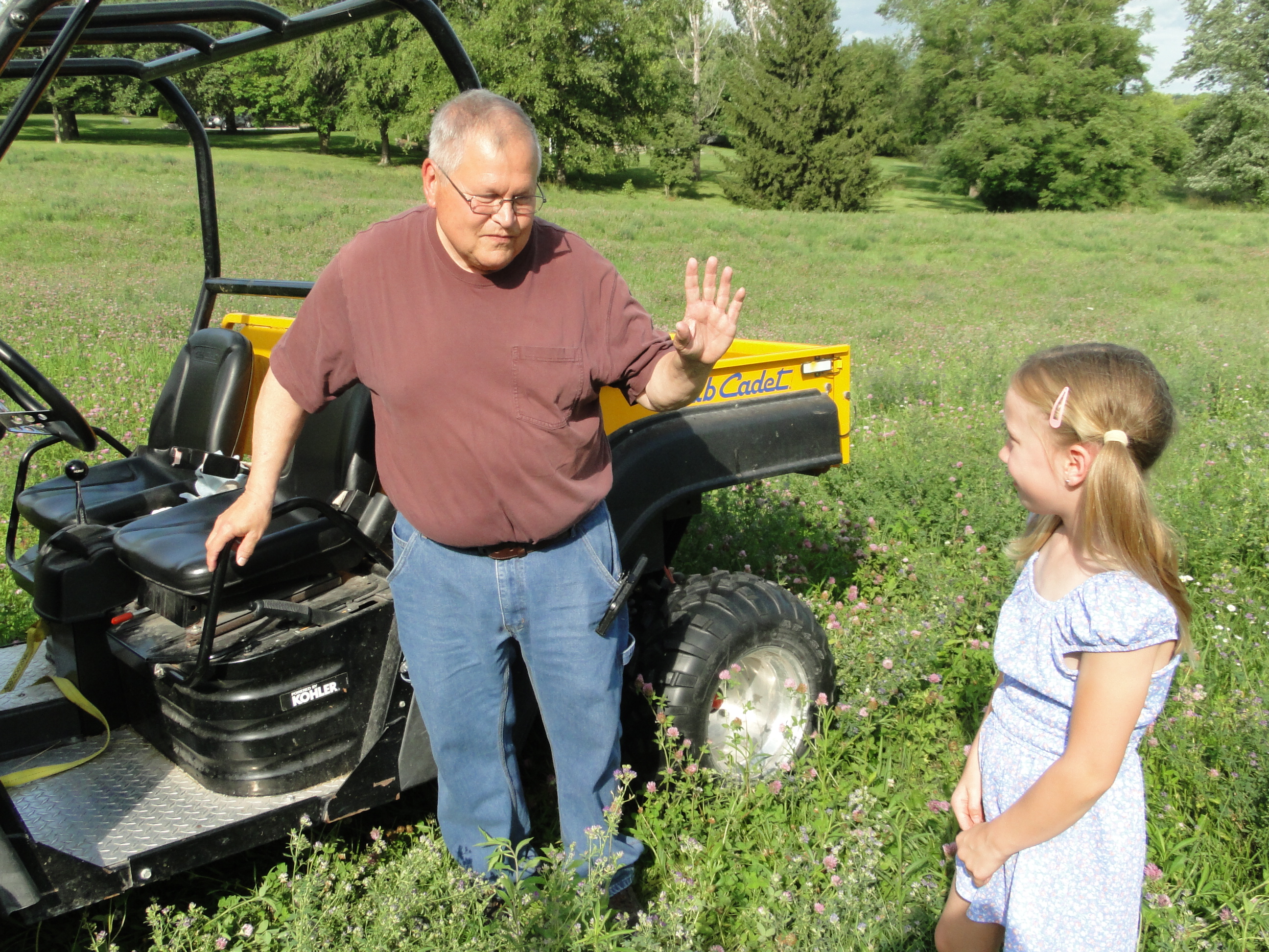 Adult instructing child not to get on UTV