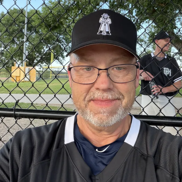Ron Watson wearing a baseball cap