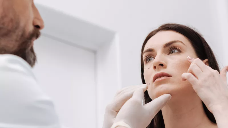 Stock photo of a provider touching a woman's face