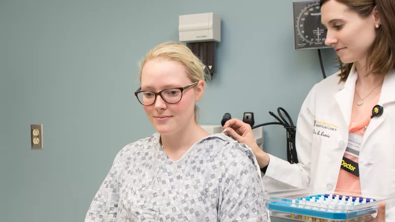 UI Health Care provider interacts with a patient during an allergy test