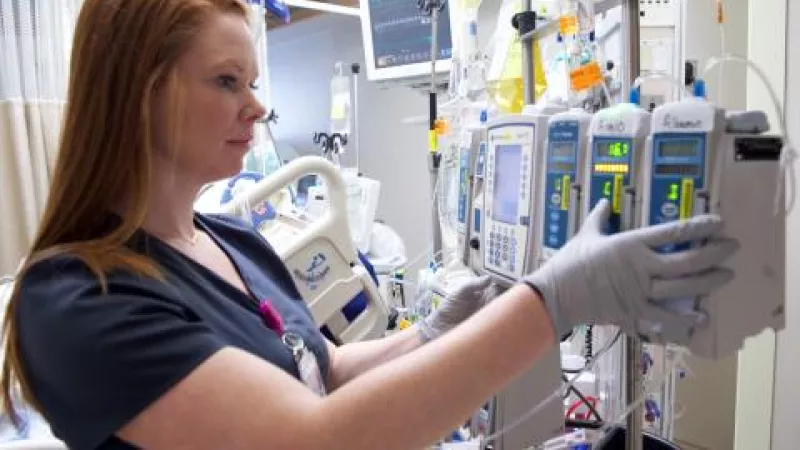 Nurse monitoring pumps in the Surgical Intensive Care Unit