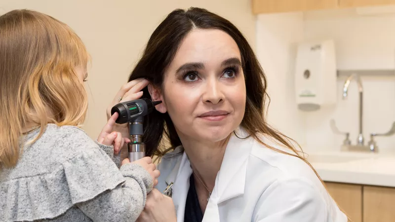 UI Health Care provider allows a child to examine her ear