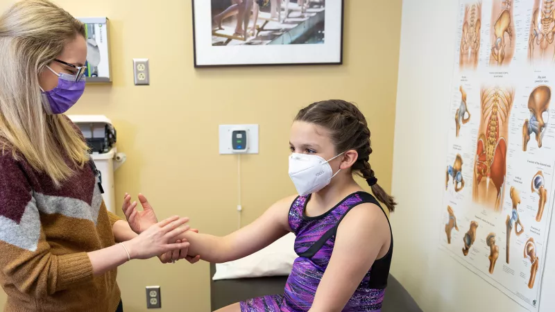 Dr. Ashlee Enzinger with simulated patients at the Sports Medicine Clinic in Iowa City on Wednesday, March 16, 2022.