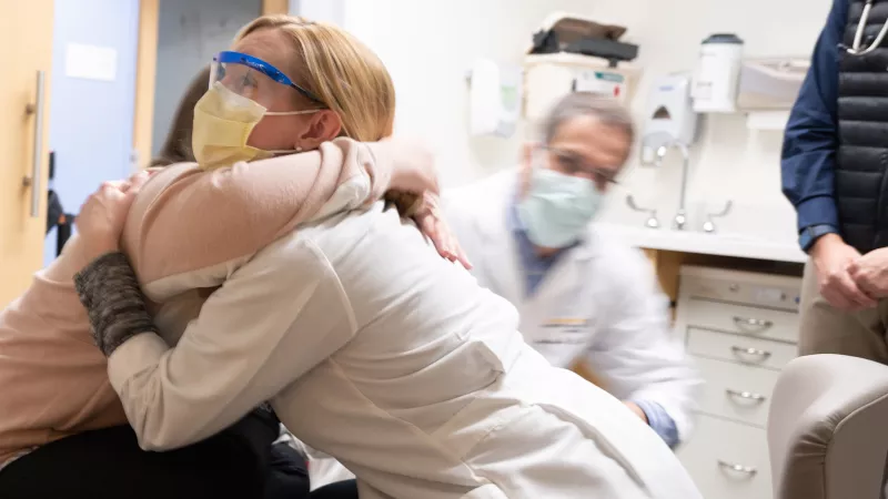Lyndsey Harshman, MD hugs a patient during an appointment