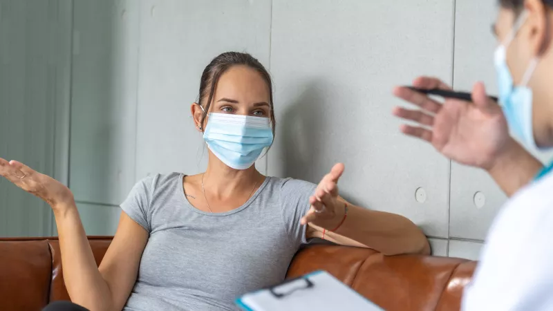 stock image of a woman and provider discussing health care