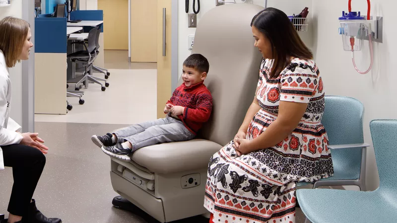UI Stead family Children's Hospital provider talks with a child and their parent