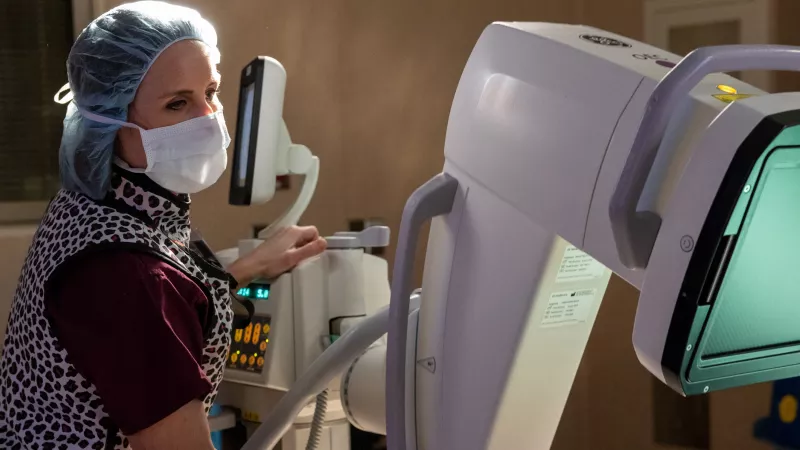 Megan Skala is a Senior Imaging Technologists in the OR. Photographed with a C-arm x-ray machine on Tuesday, Feb. 15, 2022.
