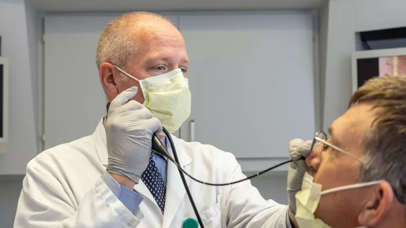 Douglas Van Daele with simulated patient in the Otolaryngology clinic on Thursday, Sept. 22, 2022.