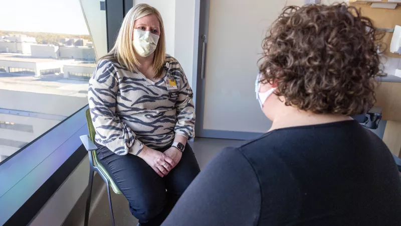 Kristin Foster, ARNP on the Psycho-oncology care team, with a patient 