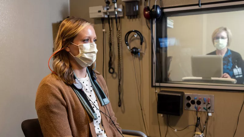 Audiologist Suzanne Dunn with a simulated patient in the Otolaryngology Clinic Thursday, Oct. 20, 2022.