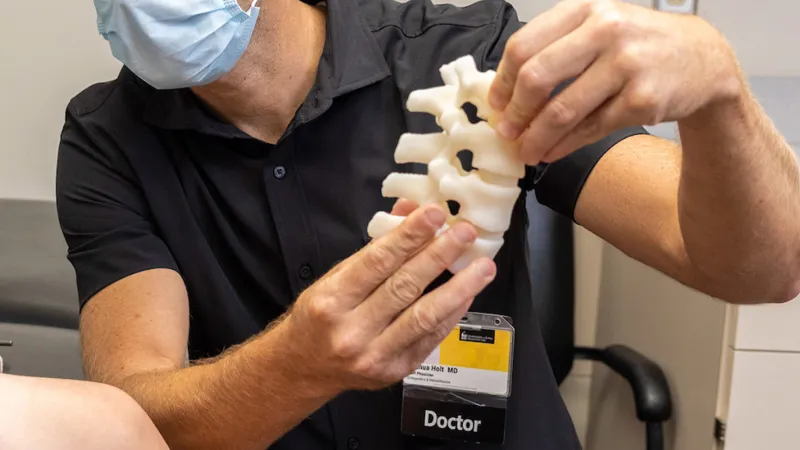 Joshua Holt with simulated pediatric patient in the Orthopedic Clinic on Monday, Aug. 22, 2022.