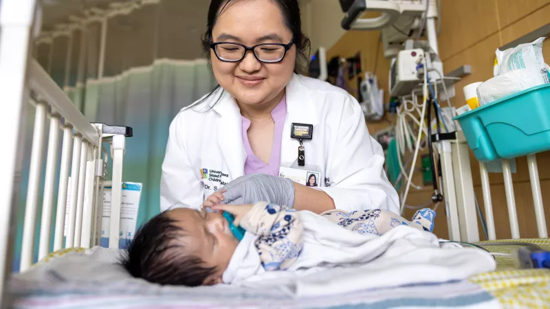 Dr. Lee in NICU with inpatient preemie baby