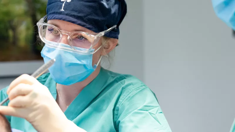 Chandler Jansen, MD, Micrographic Surgery and Dermatologic Oncology Fellow, handles a tissue sample in the dermatology clinic on the UI Health Care university campus on Monday, Sept. 30, 2024.