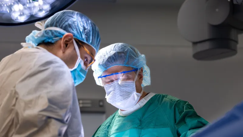 Jeremy Greenlee (green coat) performs a stage 2 subthalamic nucleus (STN) deep brain simulation (DBS) surgery with post doctoral clinical trainee Juan Vivanco Suarez on Monday, Dec. 16, 2024. 