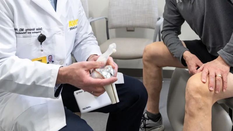 Dallas Vanorny, MD PhD, with simulated patient in the orthopedics clinic at UI Health Care Medical Center North Liberty on Monday, Feb. 24, 2025.