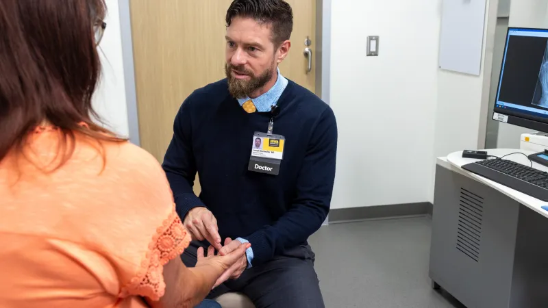 Joseph Buckwalter V, MD PhD, with simulated hand and wrist patient in the orthopedics clinic at UI Health Care Medical Center North Liberty on Tuesday, April 29, 2025. Patient consent on file. 