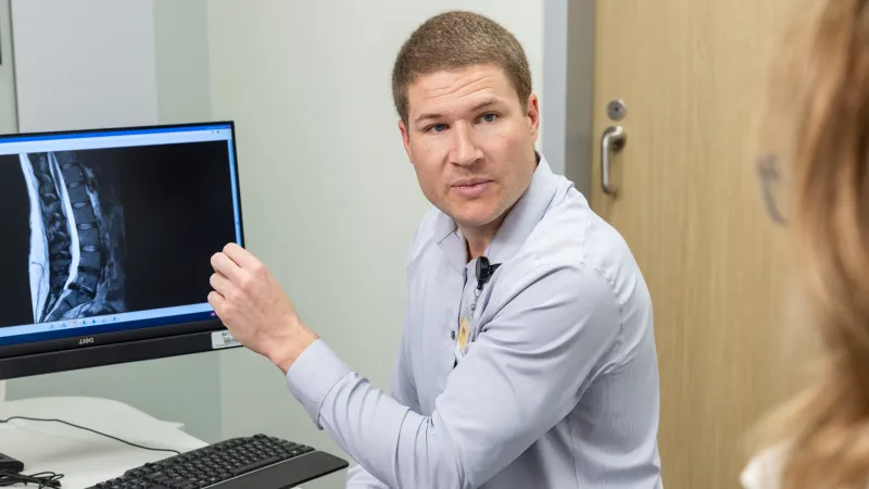 Joshua Eisenberg, MD, with simulated spine patient in the orthopedics clinic at UI Health Care Medical Center North Liberty on Tuesday, April 29, 2025. 