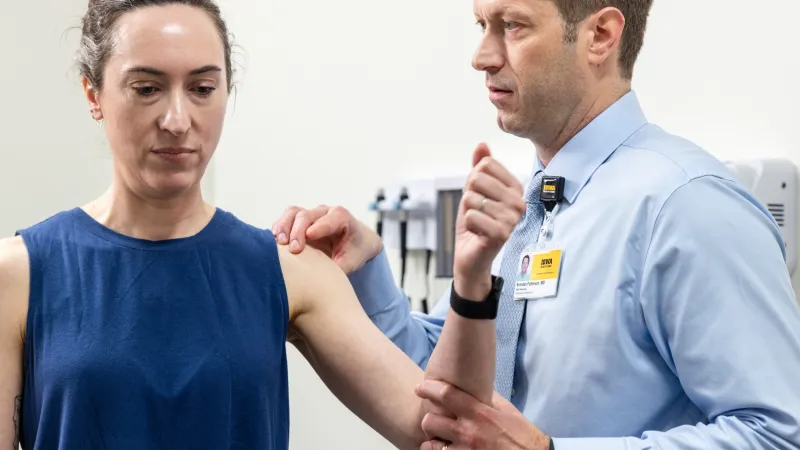 Brendan Patterson, MD, with simulated shoulder patient in the orthopedics clinic at UI Health Care Medical Center North Liberty on Tuesday, April 29, 2025. 