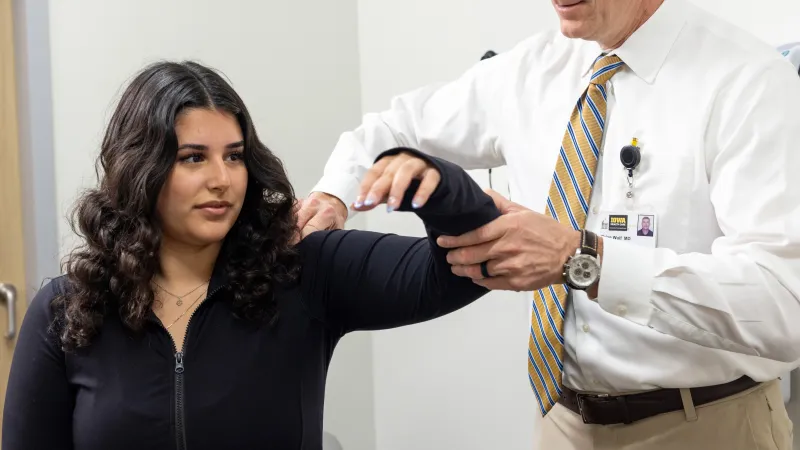 Brian Wolf, MD, with simulated patient in the Sports Medicine clinic at UI Health Care Medical Center North Liberty on Tuesday, April 29, 2025. 
