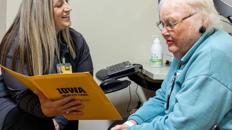 Staff nurse Alisha Neilson in the clinic with patient at Holden Comprehensive Cancer Center on the UI Health Care university campus on Monday, May 5, 2025. Patient consent on file. 