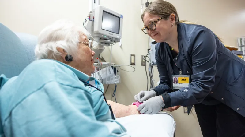 Molly Gore, ADN RN, with infusion patient at Holden Comprehensive Cancer Center on the UI Health Care university campus on Monday, May 5, 2025. Patient consent on file. 