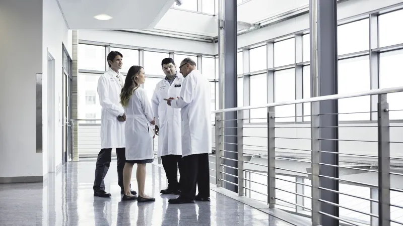 A group of holden comprehensive cancer center providers meeting in the MERF lobby