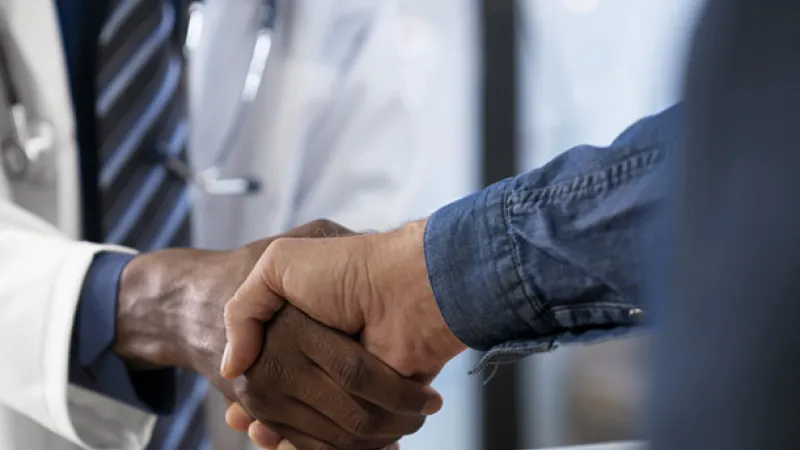 UI Health Care provider shaking hands with a patient