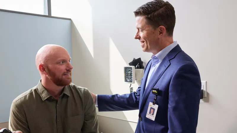 A Mission Cancer + Blood provider and patient have a conversation in a clinical room.