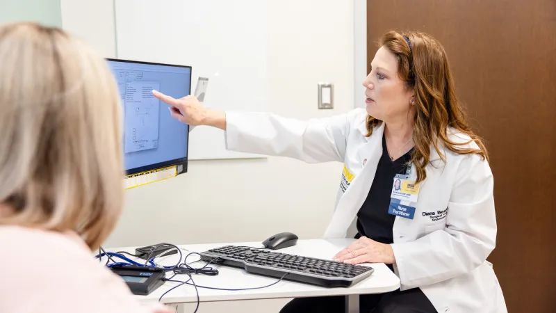 Diana Besler, ARNP, with simulated patient in the High-Risk Breast Clinic 