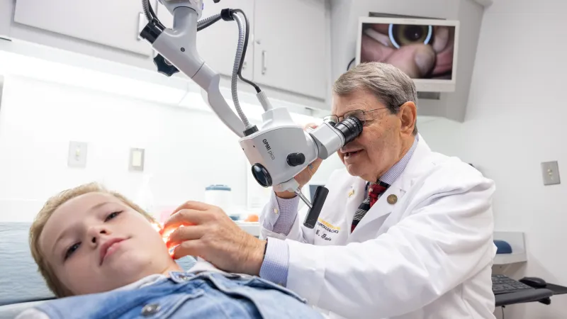 Doctor looking in child's ear