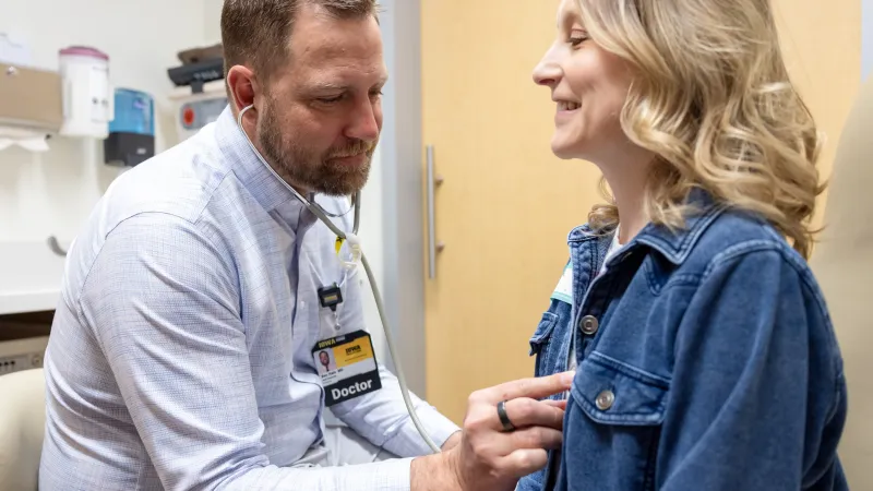Doctor listening to female patient heart