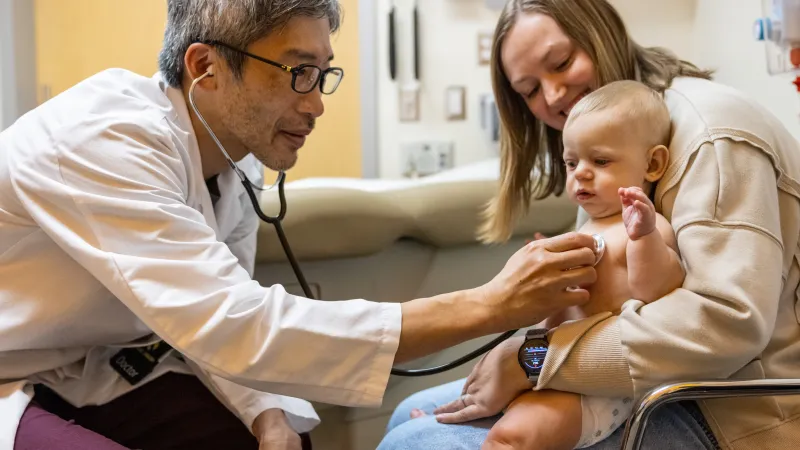  Yuki Nakamura, MD, and Tina Davenport, ARNP MSN, with a pediatric patient 