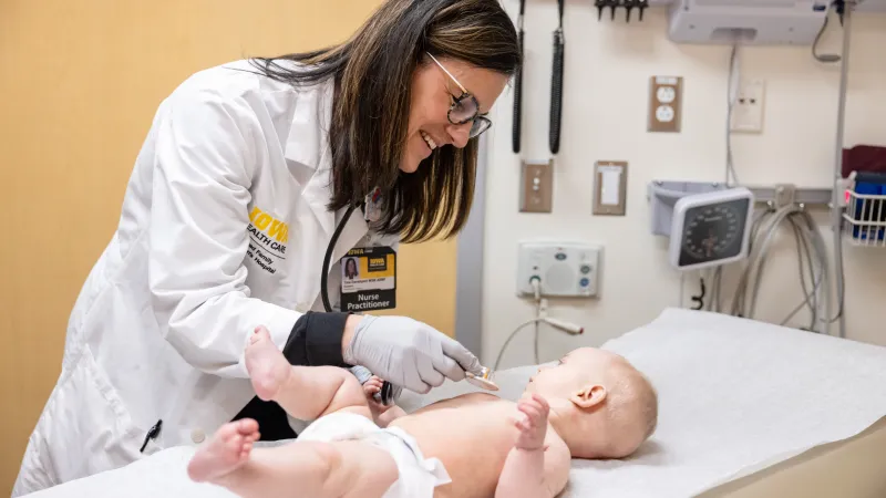 Pediatrician checking baby heartbeat