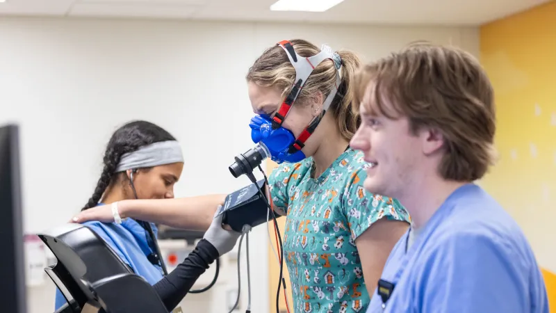 Cardiac rehab exercise specialist Jasyn Gohl and student Imani Busch in the exercise lab with a patient. 