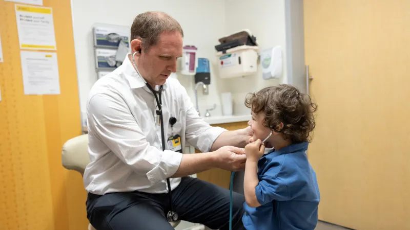 Mark Olson, PA-C, with pediatric patient in the UI Stead Family Children’s Hospital 