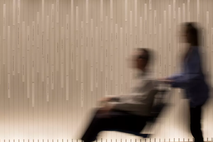 Blurry visual of patient in wheelchair in the hallway