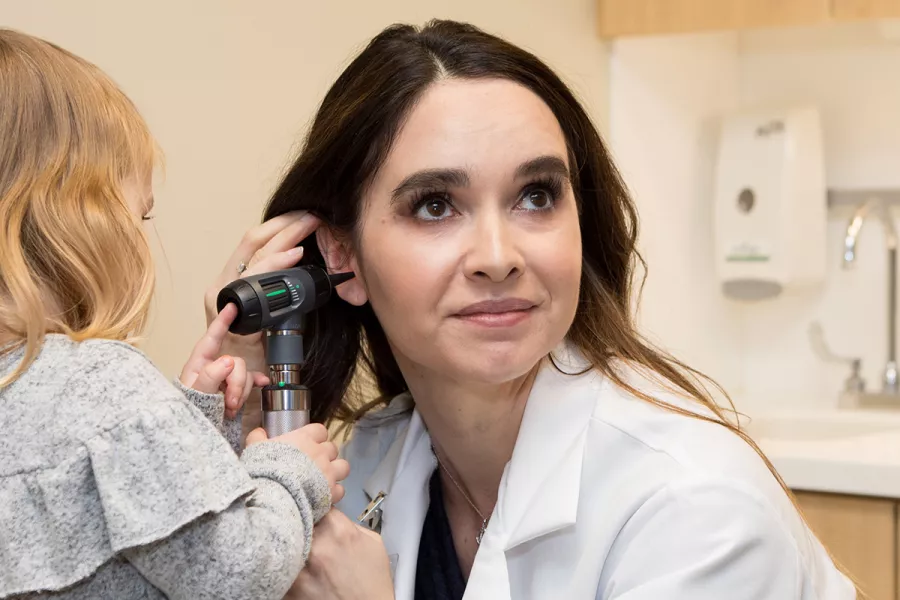 UI Health Care provider allows a child to examine her ear