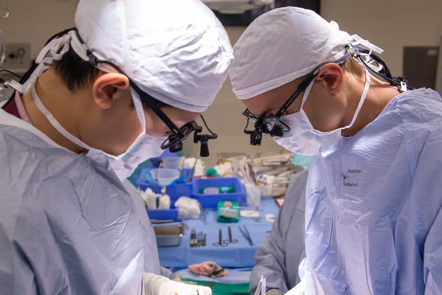 Mohammad Bashir (right) and thoracic surgery fellow Albert Pai perform a pulmonary/tricuspid valve repair/replacement at UIHC on Friday, Oct. 22, 2021.