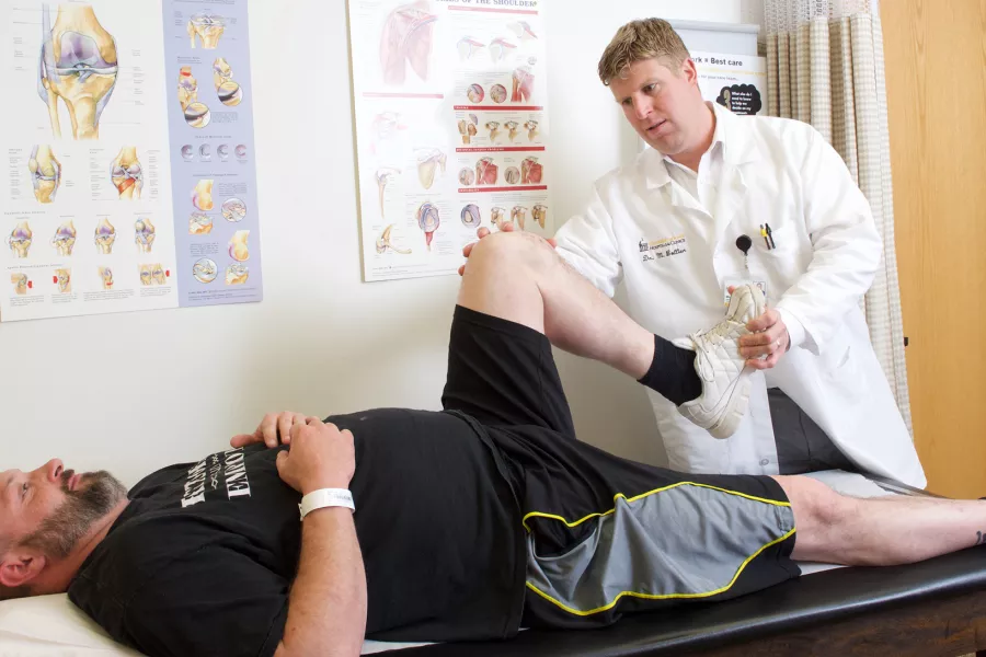 UI Health Care provider stretches a patient's knee