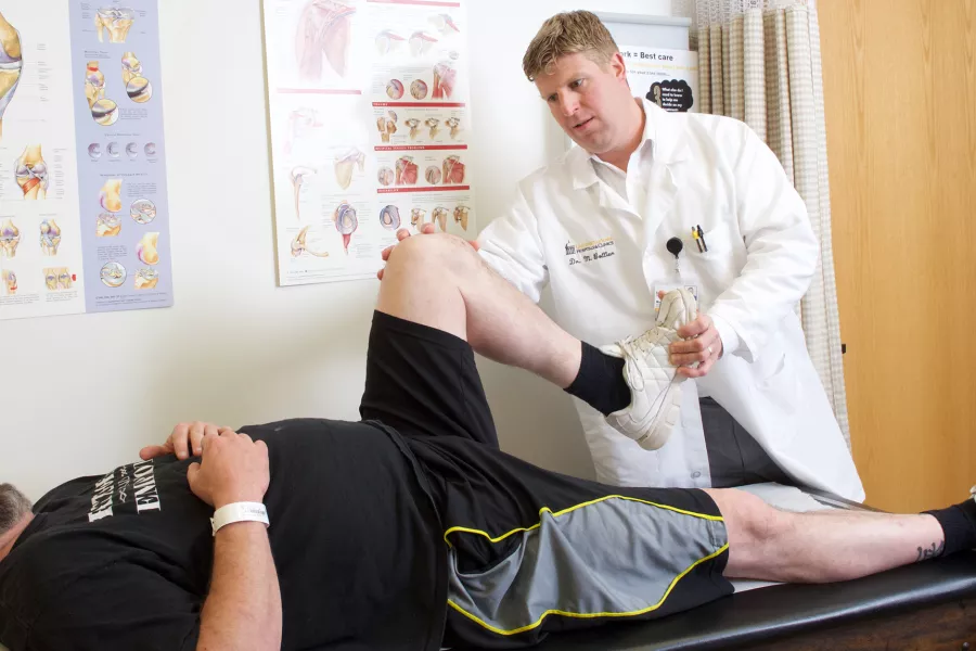 UI Health Care provider stretches a patient's knee