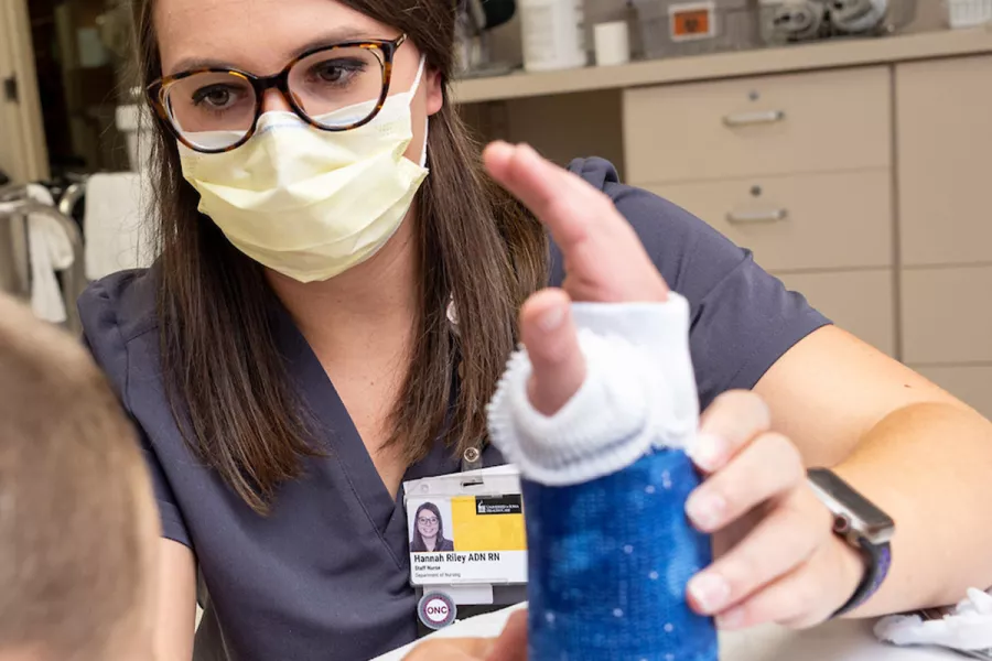 Nurse Hannah Riley puts a cast on a simulated patient in the Orthopedic Clinic on Monday, Aug. 22, 2022.