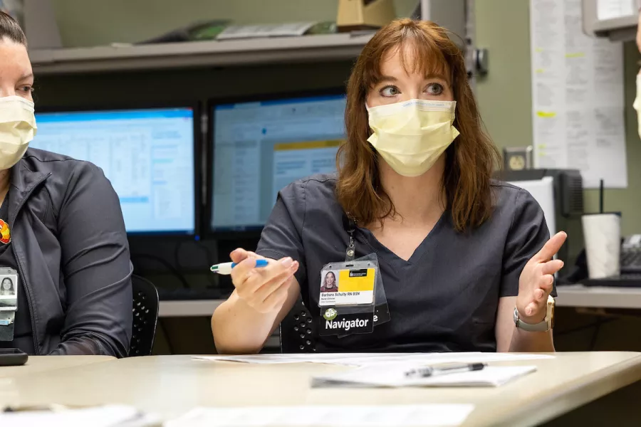 Nurse Tyler Voss and navigator Barbara Schulty participate in a morning discharge huddle on 4JPP Medical-Surgical Oncology unit. Photographed on Thursday, Nov. 10, 2022.