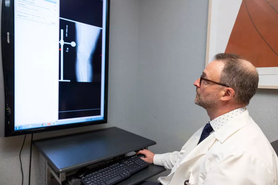 Nicolas Noiseux templates for an upcoming total knee replacement surgery on Tuesday, Aug. 30, 2022. Portion of image has been blurred to obscure patient information.