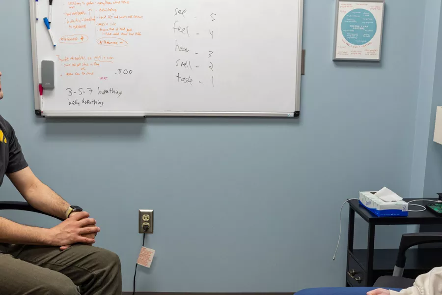 Michael Berrebi PhD, LMHC, Sport and Performance Psychology Specialist, Sr. Behavioral Health Clinician, with a simulated patient in the Iowa City sports medicine clinic on Monday, May 6, 2024.