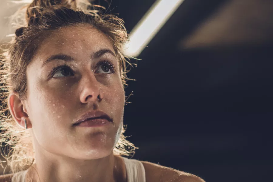 Stock image of a female athlete sweating after a workout.