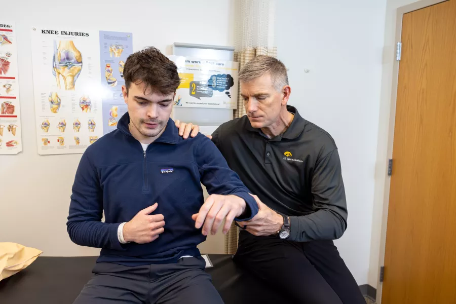 Brian Wolf with shoulder patient at UI Sports Medicine on Wednesday, April 5, 2023. Patient consent on file.