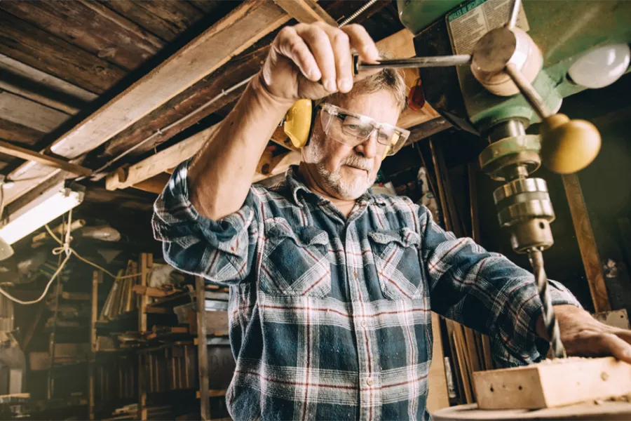 Stock photo of a man wearing protective gear woodoworking